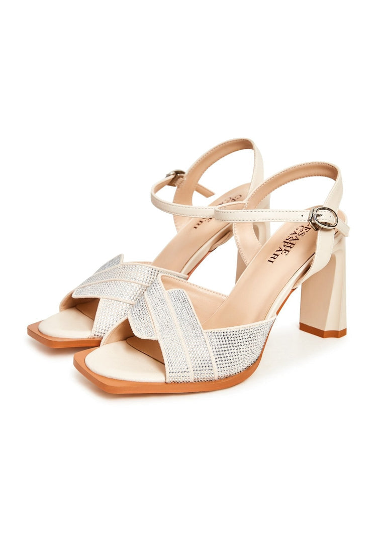 A pair of stylish beige sandals with elevated elegance, perfect for chic women's footwear fashion.