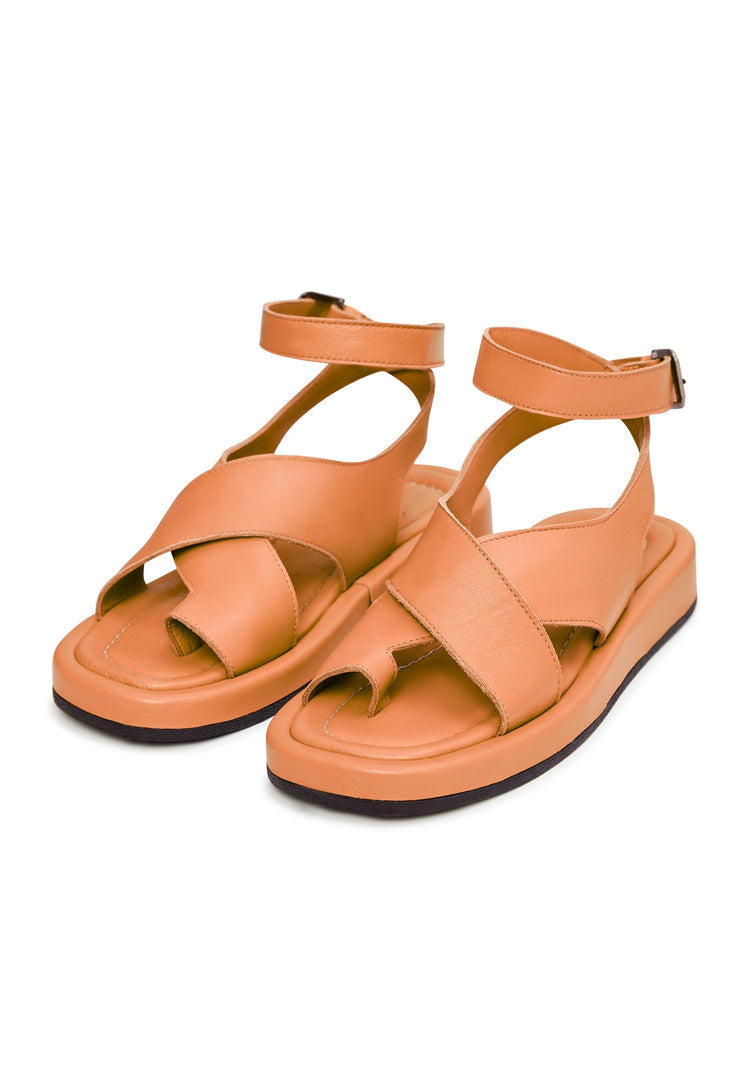 A stylish pair of leather platform sandals in vibrant orange color, perfect for adding a pop of color to your outfit.