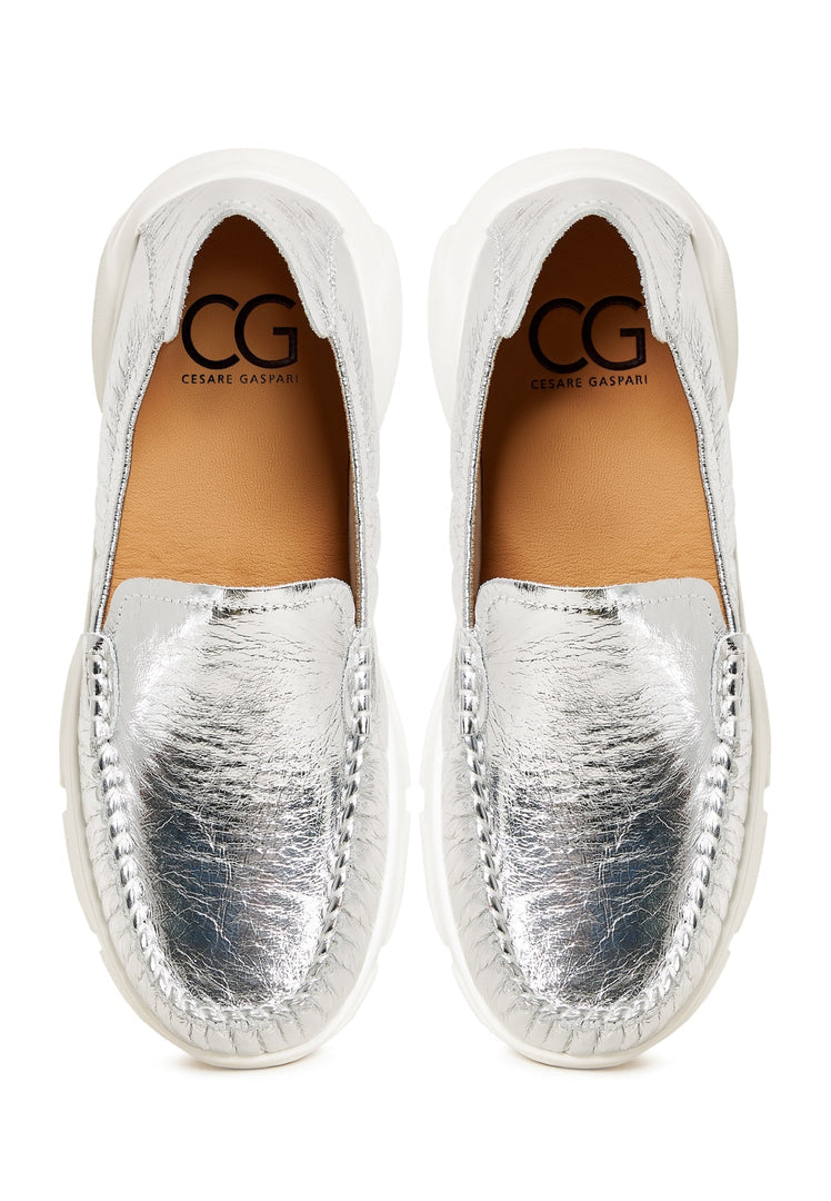 A pair of stylish silver leather platform moccasins, known as Alisa silver shoes, featuring a modern and trendy design perfect for any occasion.