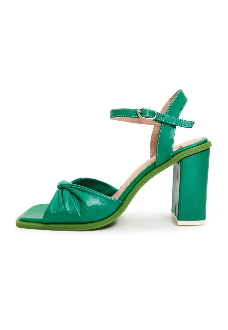 A pair of stylish and elegant green block heels, a timeless and classic choice for footwear.