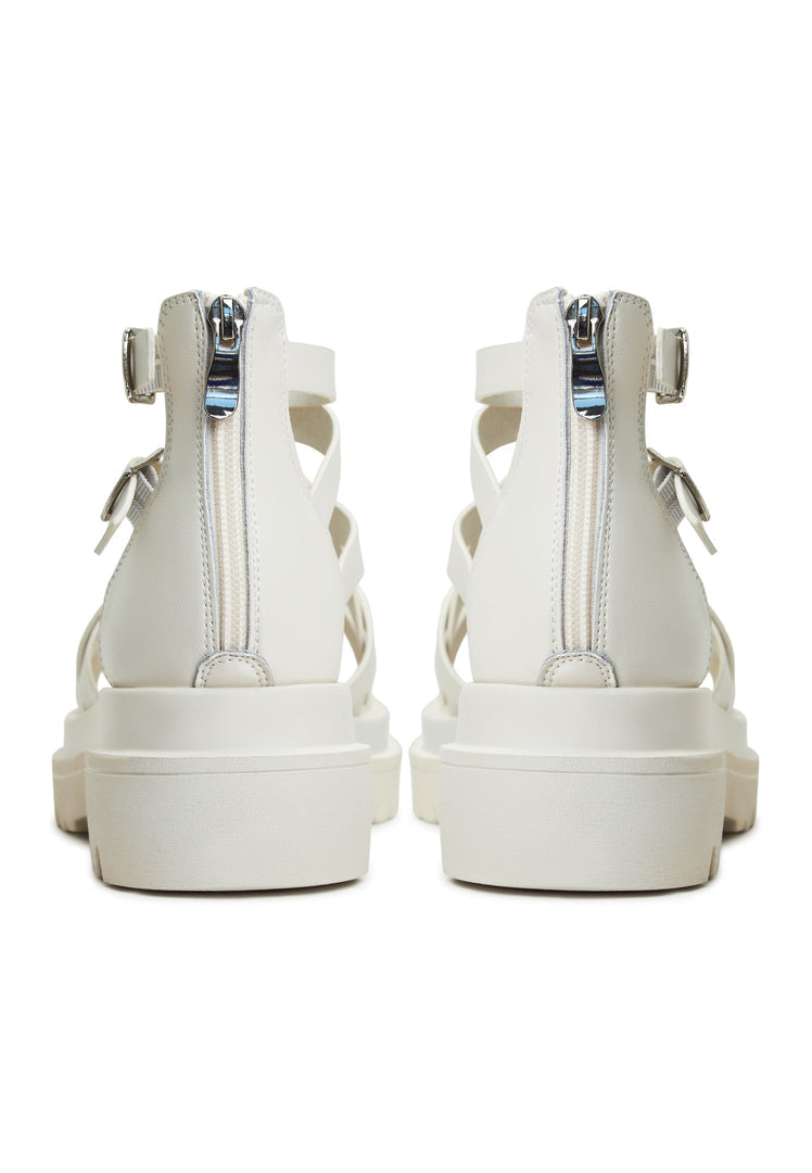 A close-up image of trendy white platform sandals, the Tatiana platform sandals, for women, featuring a stylish wedge heel and strappy design.