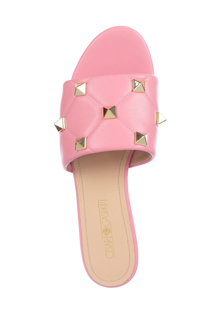 A pair of stylish designer pink Rockstud sandals, also known as Mila sandals, with intricate studded details for a chic and trendy look.