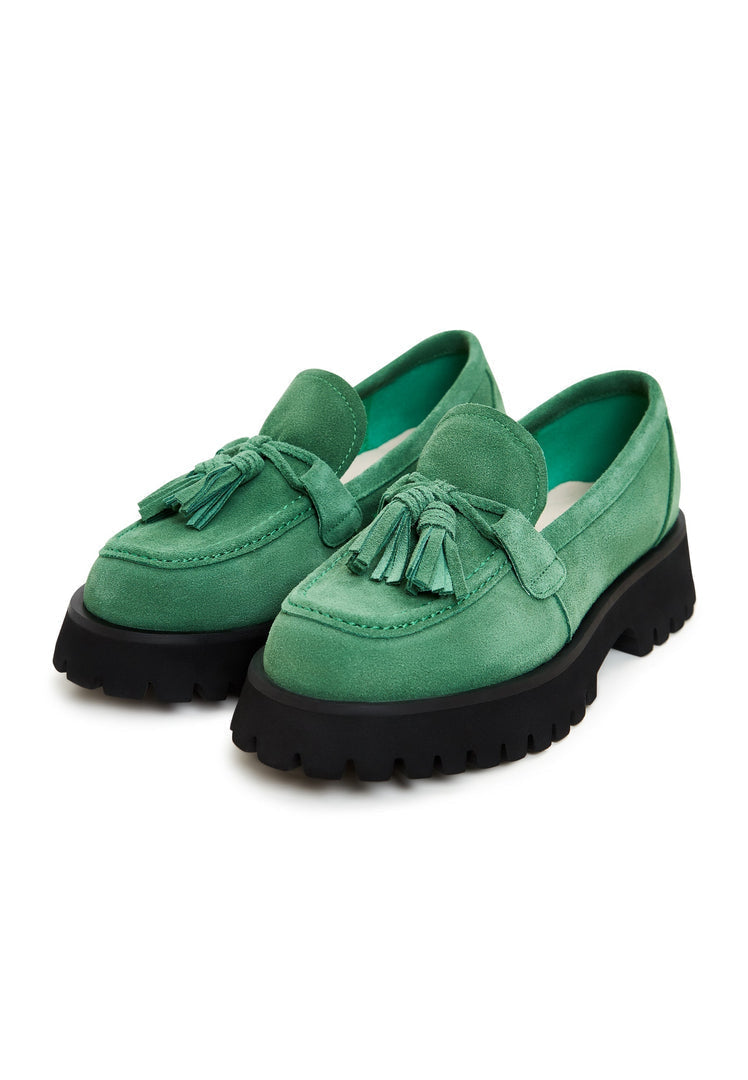A stylish pair of platform loafers designed by Ksenia in a trendy green color, perfect for women's footwear fashion.