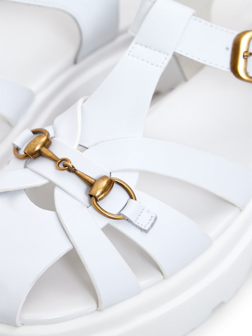 A chic pair of white platform sandals, combining urban flair with classic style.