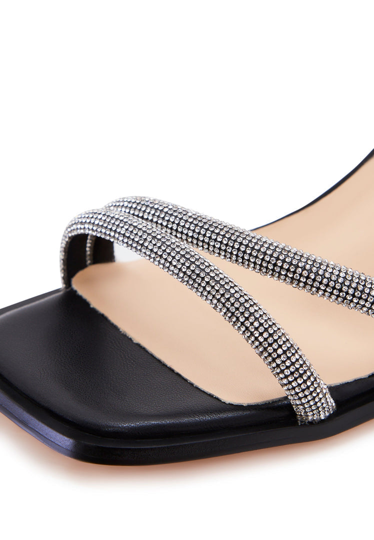 A stylish pair of black leather block heel sandals with an open toe design.
