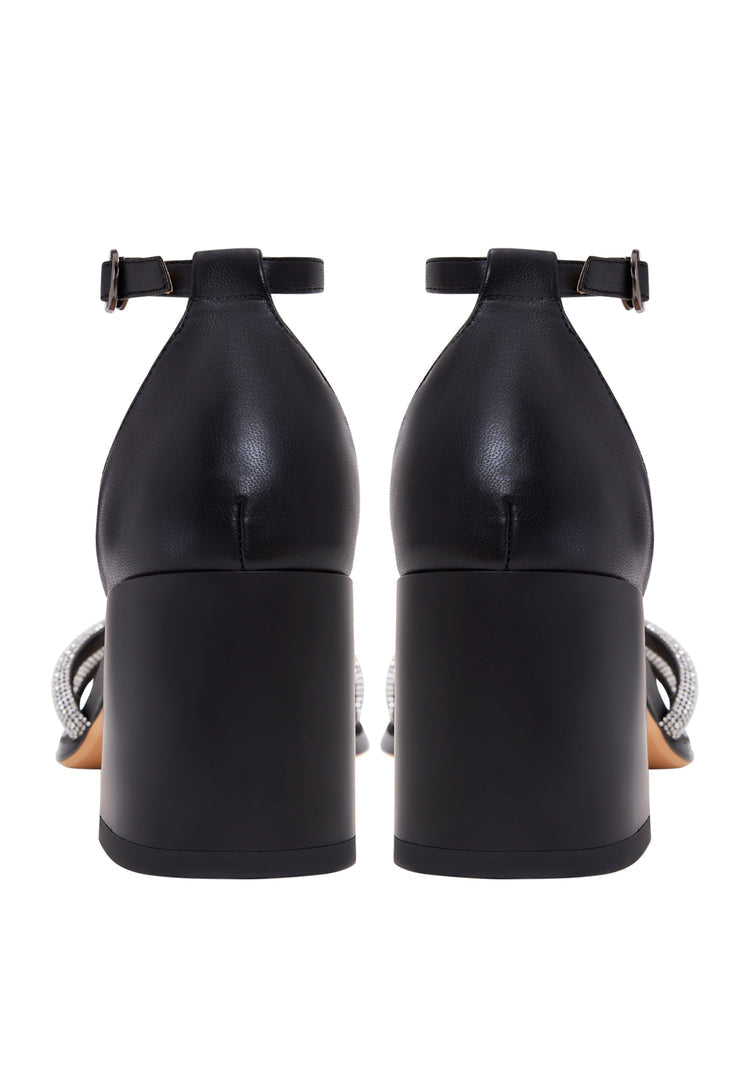 A stylish pair of black leather block heel sandals with an open toe design, perfect for a chic and comfortable look.