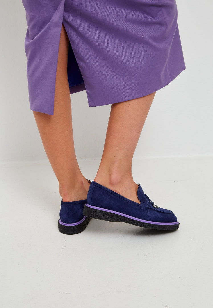 A stylish pair of navy blue slip-on suede loafers for men, perfect for a classy and elegant look.