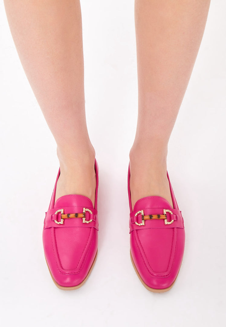 A pair of high quality fuchsia leather loafers, the epitome of premium leather footwear for a touch of luxury.