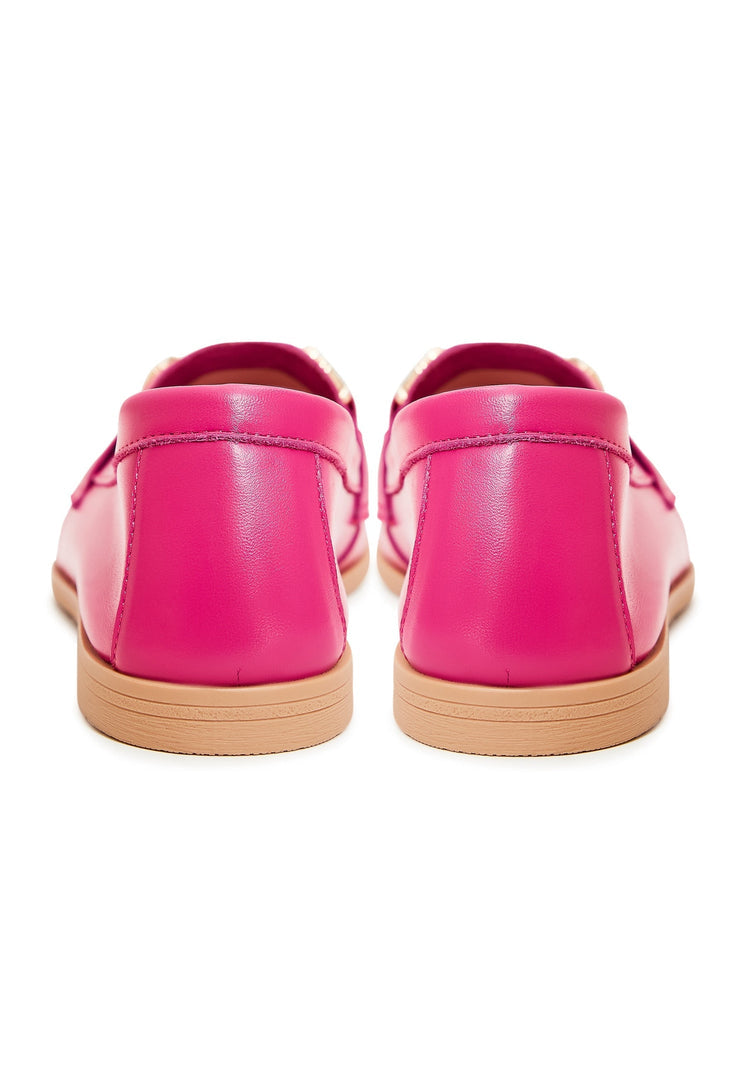 A pair of luxurious fuchsia leather loafers, showcasing high-quality craftsmanship and premium materials in this image of stylish footwear.