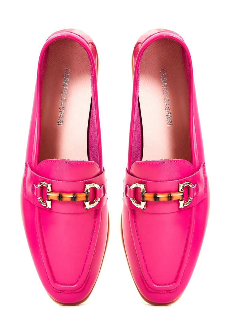 A stylish pair of fuchsia leather loafers, crafted from premium, high-quality leather - the epitome of luxury footwear.