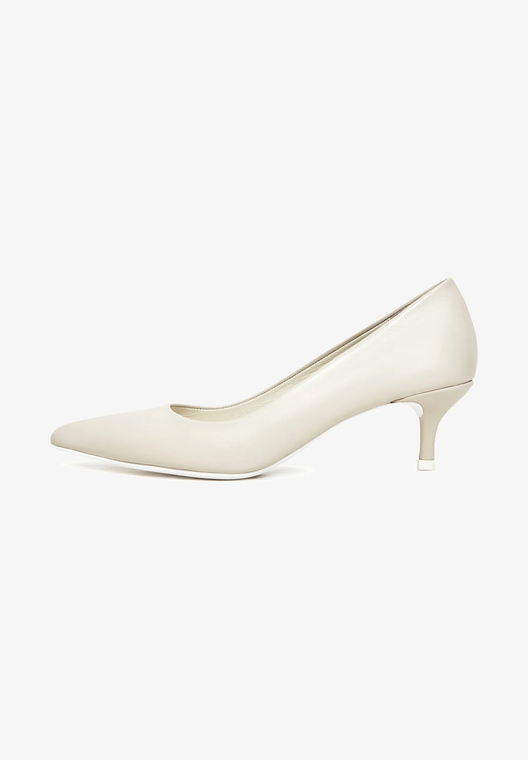 A pair of elegant luxe off white pumps, perfect as luxe heels or designer pumps for a white wedding ensemble.