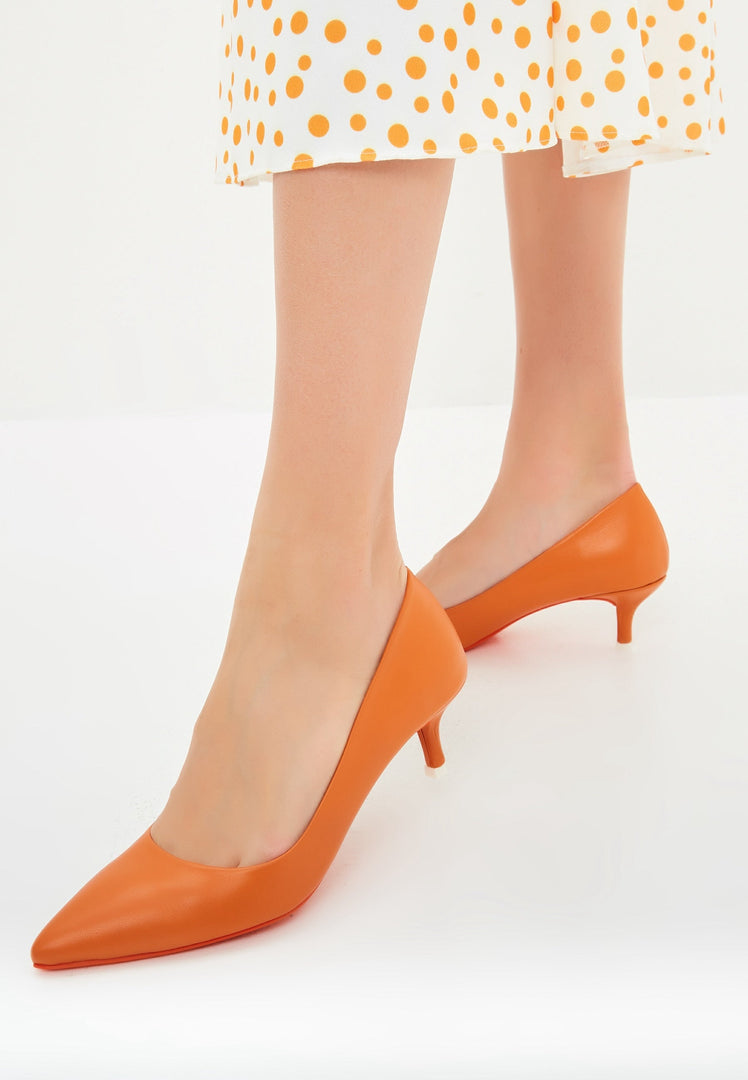 A stylish pair of elegant orange designer pumps, showcasing high-end luxury heels for a sophisticated and chic look.