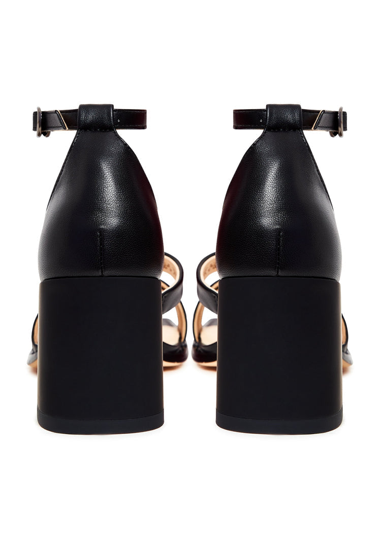 A stylish pair of black open toe sandals with a leather block heel, perfect for any fashion-forward woman's footwear collection.