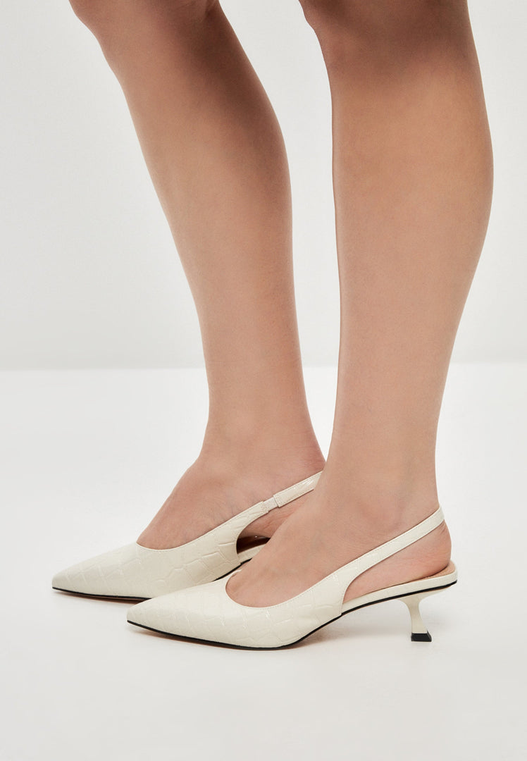 A pair of elegant off white stiletto heels, perfect fashion pumps for women's footwear.