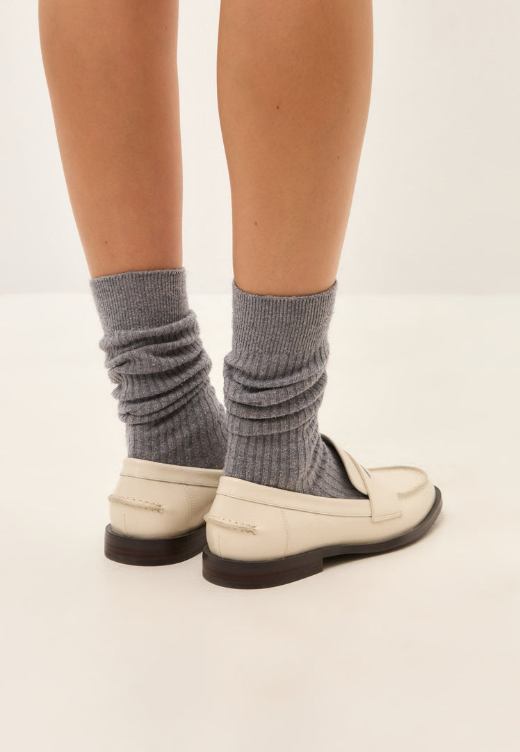 A pair of fashionable white leather block heeled loafers for women, perfect for a chic and on-trend look.