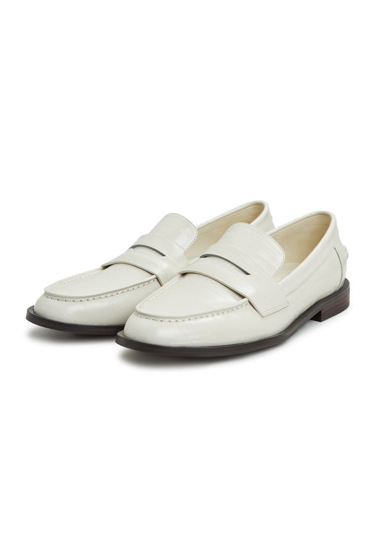 A stylish pair of white leather block heeled loafers, perfect for women who love fashionable and comfortable slip-on shoes.