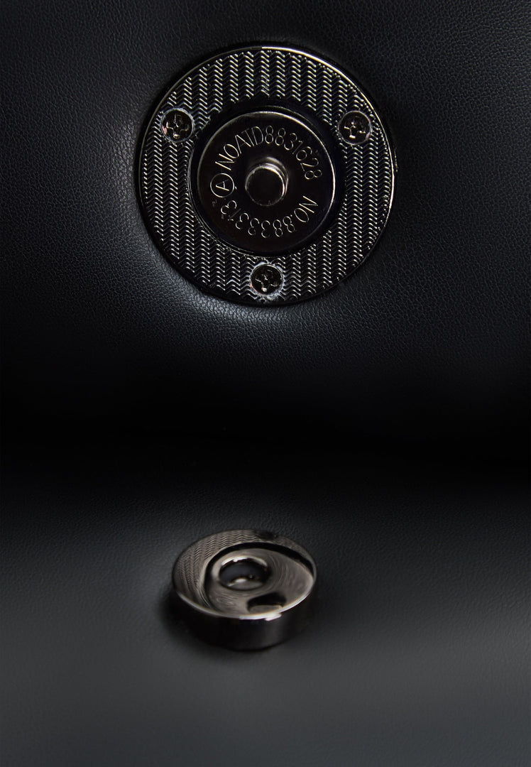 A stylish black quilted clutch bag that adds a touch of elegance to any outfit.