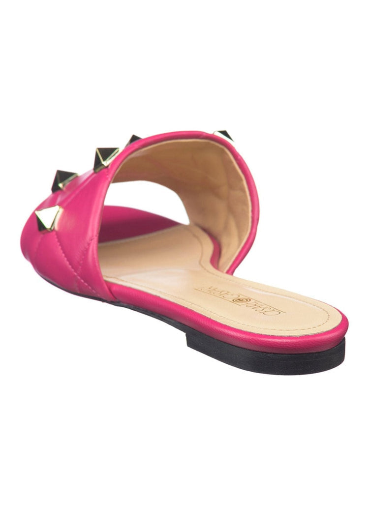 A close-up image of vibrant fuchsia Rockstud designer sandals with a chic and stylish twist, perfect for summer outings.