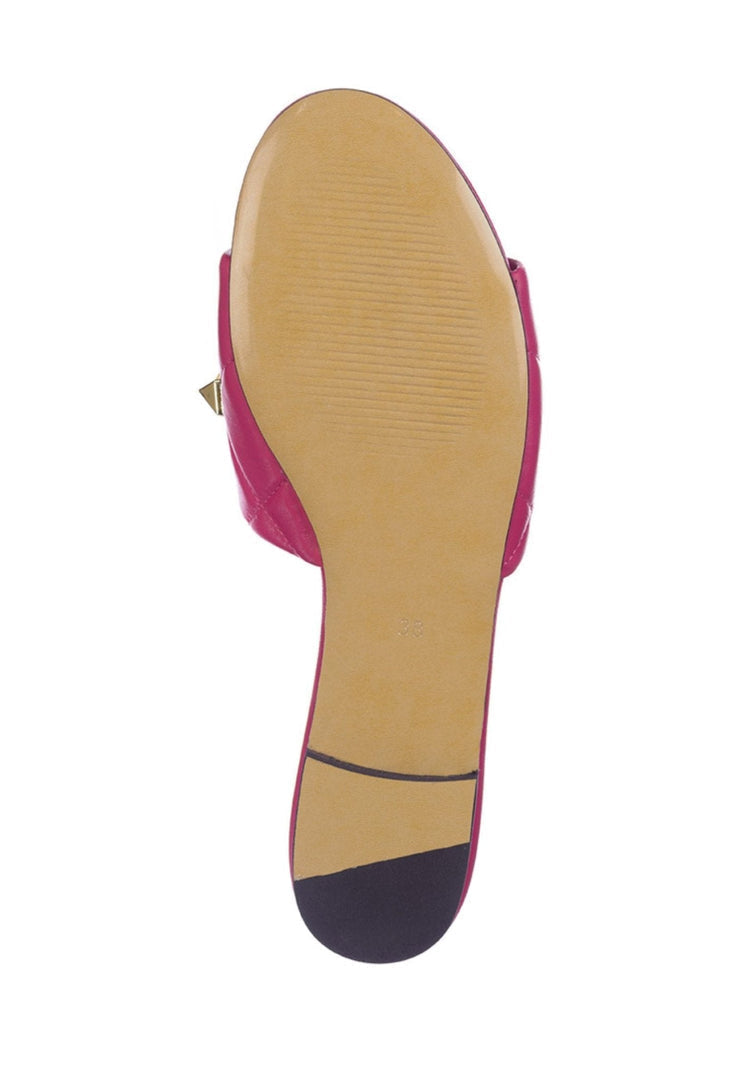 A fashionable pair of designer Rockstud fuchsia sandals, also known as Mila sandals, featuring stylish studs.