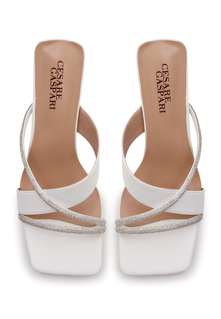 A pair of elegant white high heel sandals for women, featuring a strappy design that exudes sophistication and style.