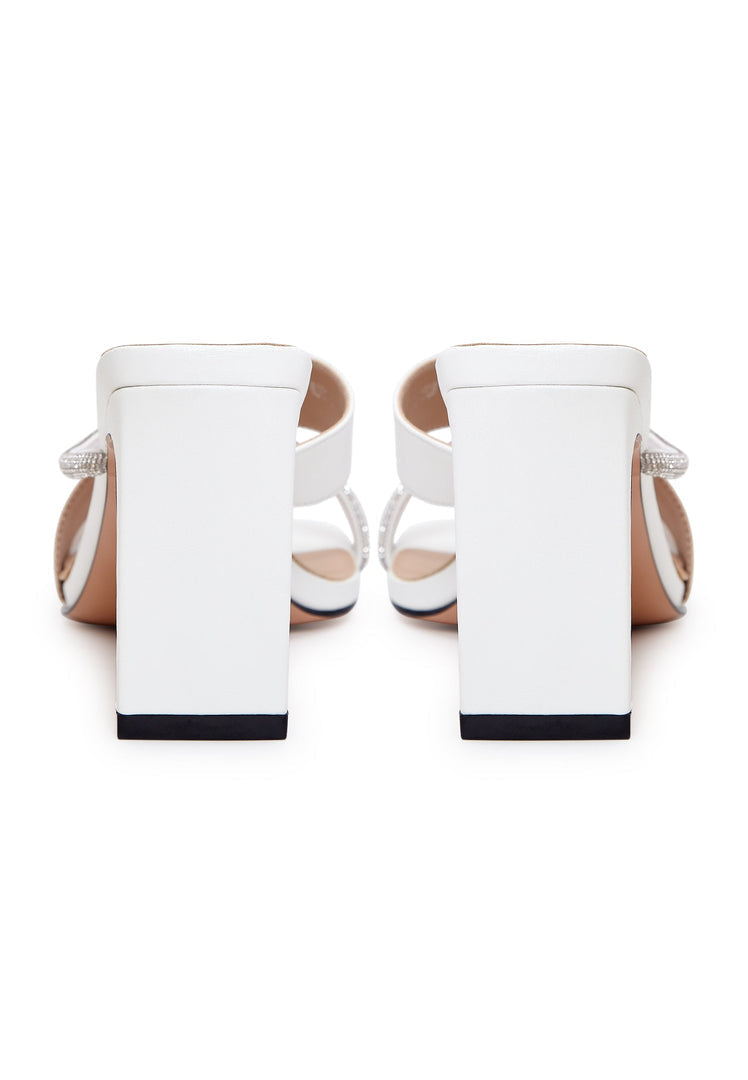 A pair of elegant white high heel sandals for women, featuring a strappy design perfect for any special occasion.