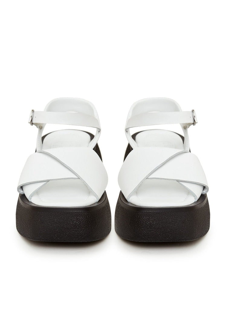 A pair of stylish white leather platform sandals with a chunky sole, perfect for summer outings and adding extra height.