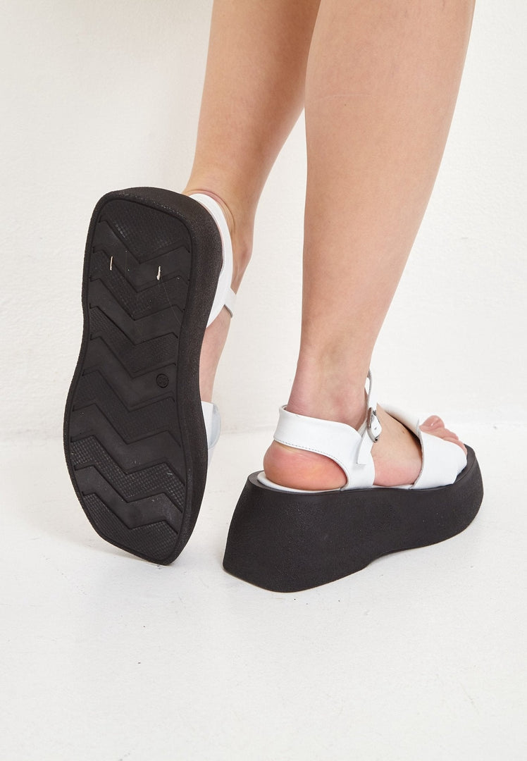 A pair of elegant white leather platform sandals, perfect for adding a touch of style and sophistication to your outfit.