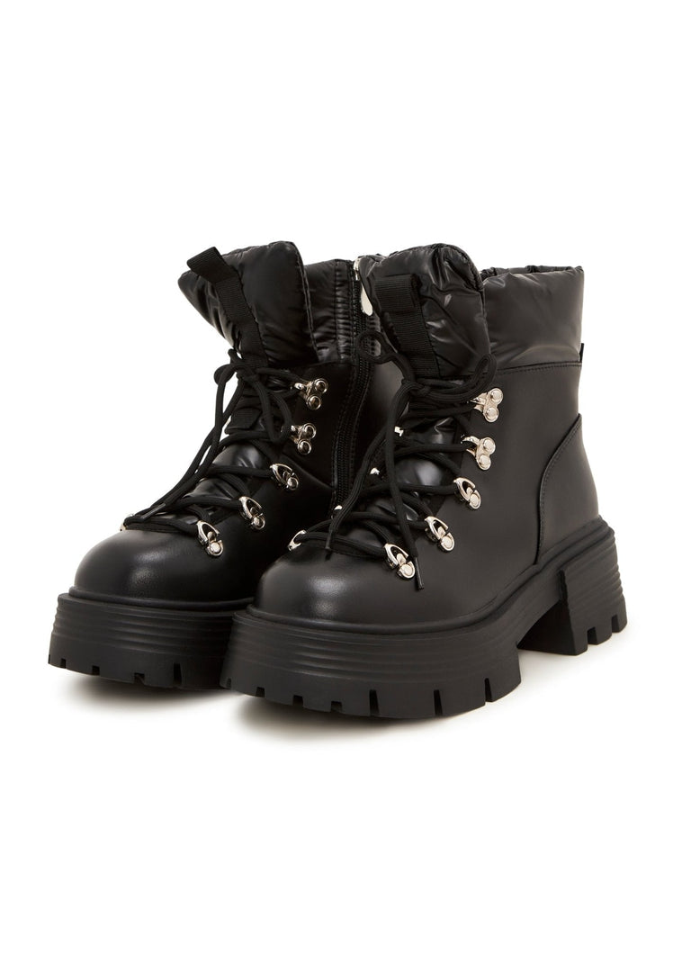 A trendy pair of peep-toe ankle boots, perfect for summer, featuring cut-out details - a must-have in women's shoe fashion trends.