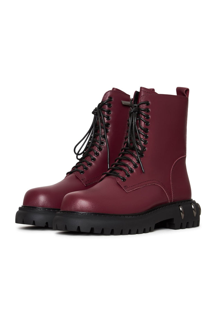 A pair of stylish lace-up combat boots with a chunky sole in a trendy bordeaux color, perfect for fashion-forward women's footwear trends.