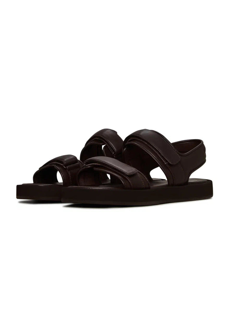 A pair of stylish women's dark brown leather sandals with velcro closure for ultimate comfort.