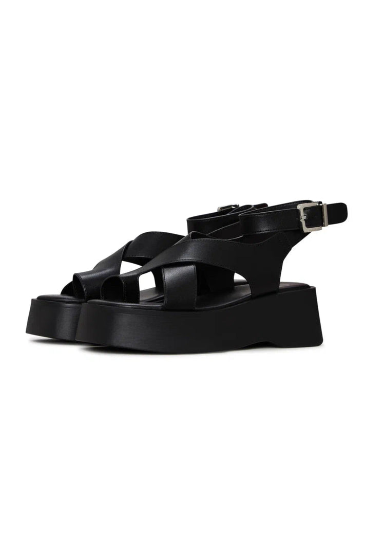 A stylish pair of black suede cross-strap sandals, perfect for women looking for trendy summer footwear with a touch of elegance.