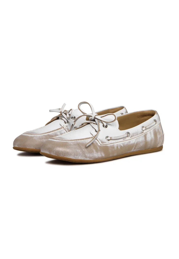 Pair of vintage leather loafers in distressed white color, a classic worn-effect footwear with an antique feel.