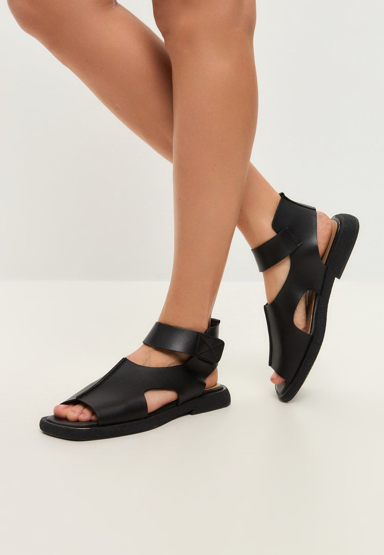 A chic pair of black leather ankle strap sandals, a perfect combination of style and comfort.