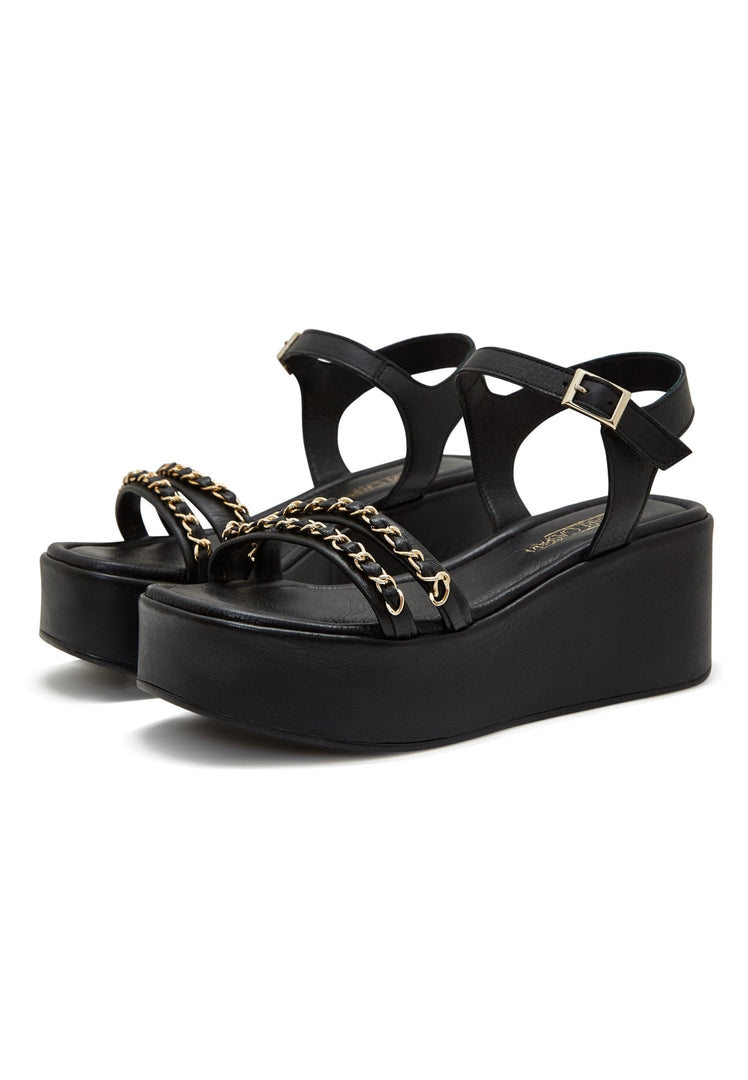 A fashionable pair of women's black platform sandals with eye-catching gold chain accents.