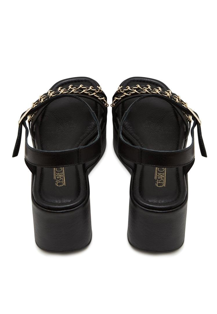 A stylish pair of women's black platform sandals with eye-catching gold chain accents, a must-have for trendy and fashionable footwear enthusiasts.