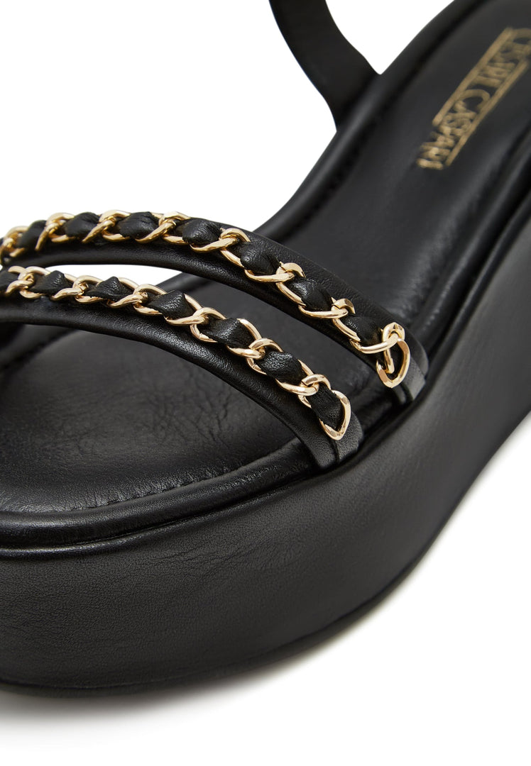 A stylish pair of black platform sandals for women, featuring elegant gold chain accents - the perfect fashionable shoes for any outfit.