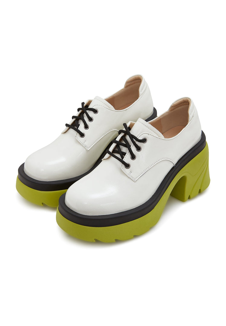 A stylish pair of white lace-up oxfords with a chunky block heel, perfect for a bold and chic women's fashion statement.