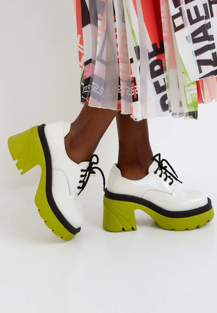 A stylish pair of women's fashion white lace-up oxfords with a chunky block heel, perfect for a bold and trendy look.