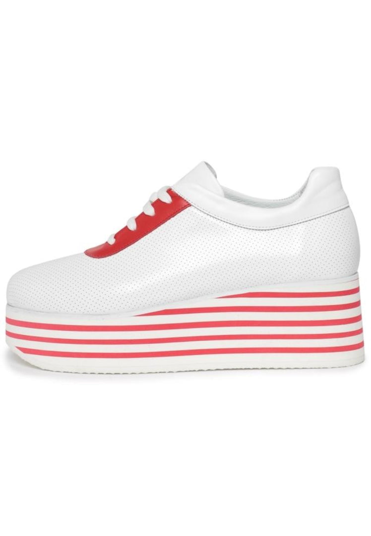 A trendy pair of red and white striped high platform sneakers on a white background.