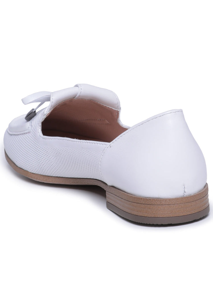 A stylish pair of men's formal white loafers with a perforated bow-tie design.