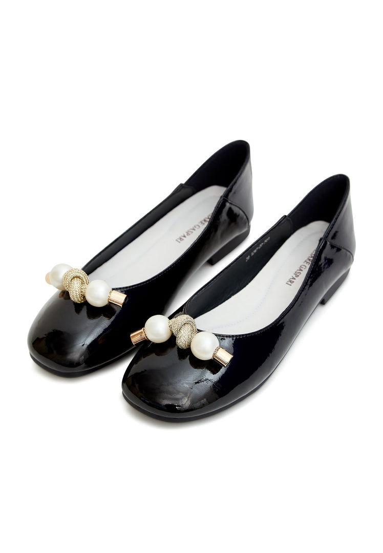 A stylish pair of black flats for women adorned with elegant pearls and a charming bow - perfect for any fashionable outfit.