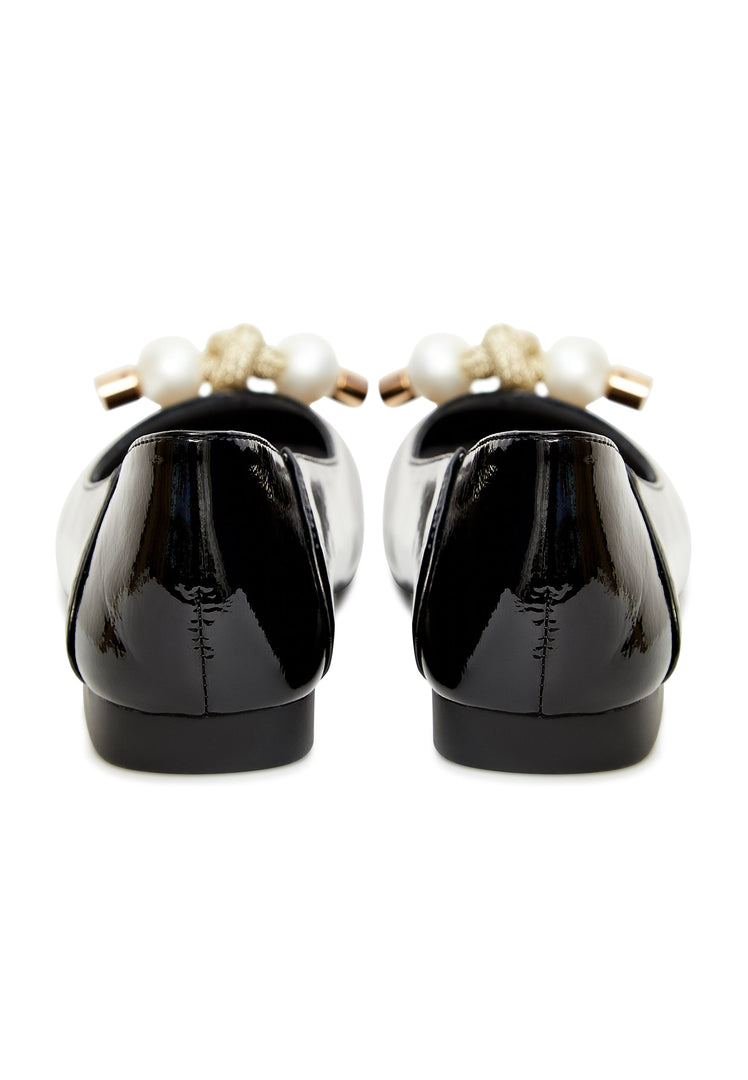 A stylish pair of women's black flats with pearl embellishments and a lovely bow detail, perfect for adding a touch of elegance to any outfit.