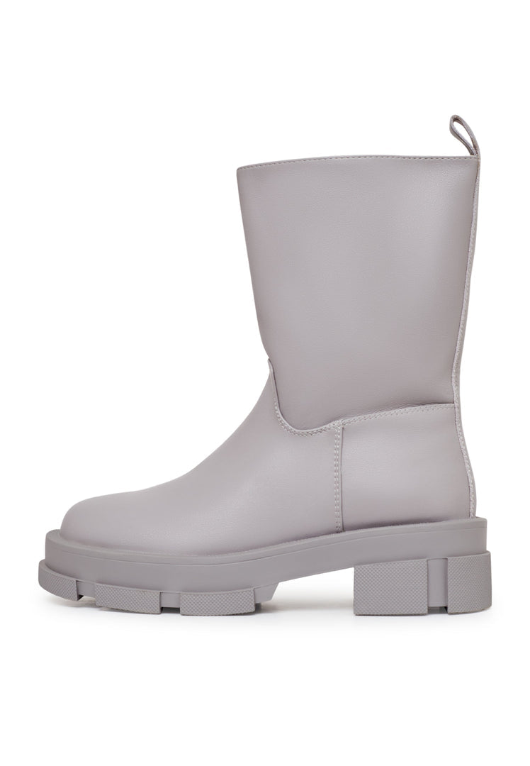 A fashionable pair of women's chunky sole leather ankle boots in beige, perfect for adding a trendy touch to any outfit.