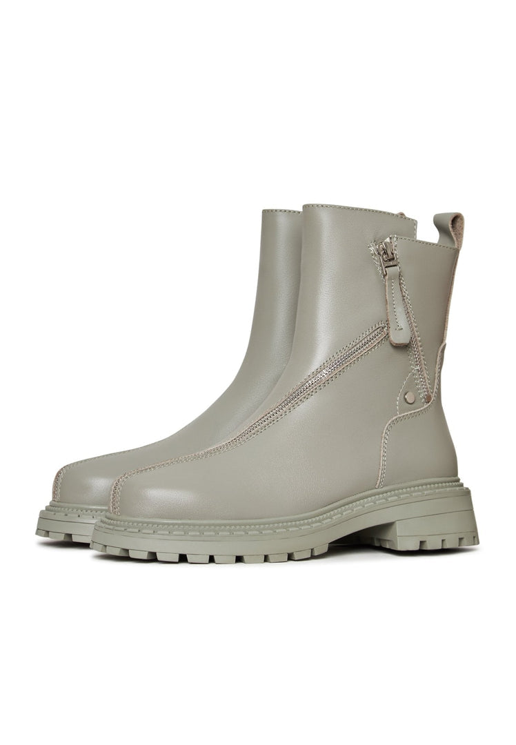 A trendy pair of women's platform ankle boots in green leather, perfect for making a fashion statement.