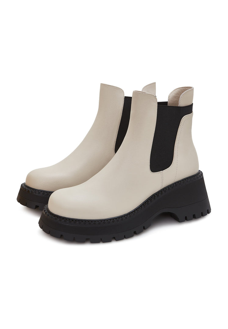 A stylish pair of women's beige chunky platform Chelsea boots, perfect for adding a fashionable touch to any outfit.
