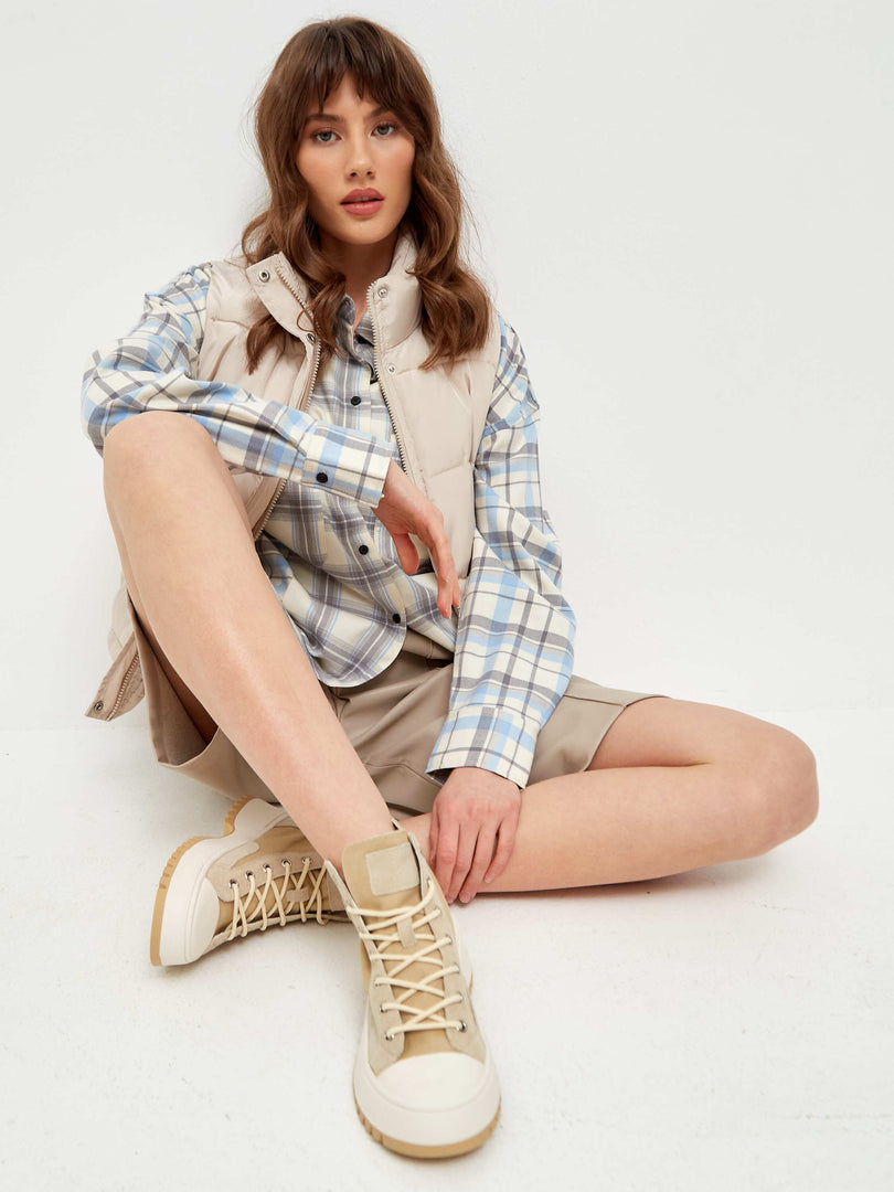 A close-up image of lace-up high top sneakers with a textured design, perfect for casual and stylish wear.
