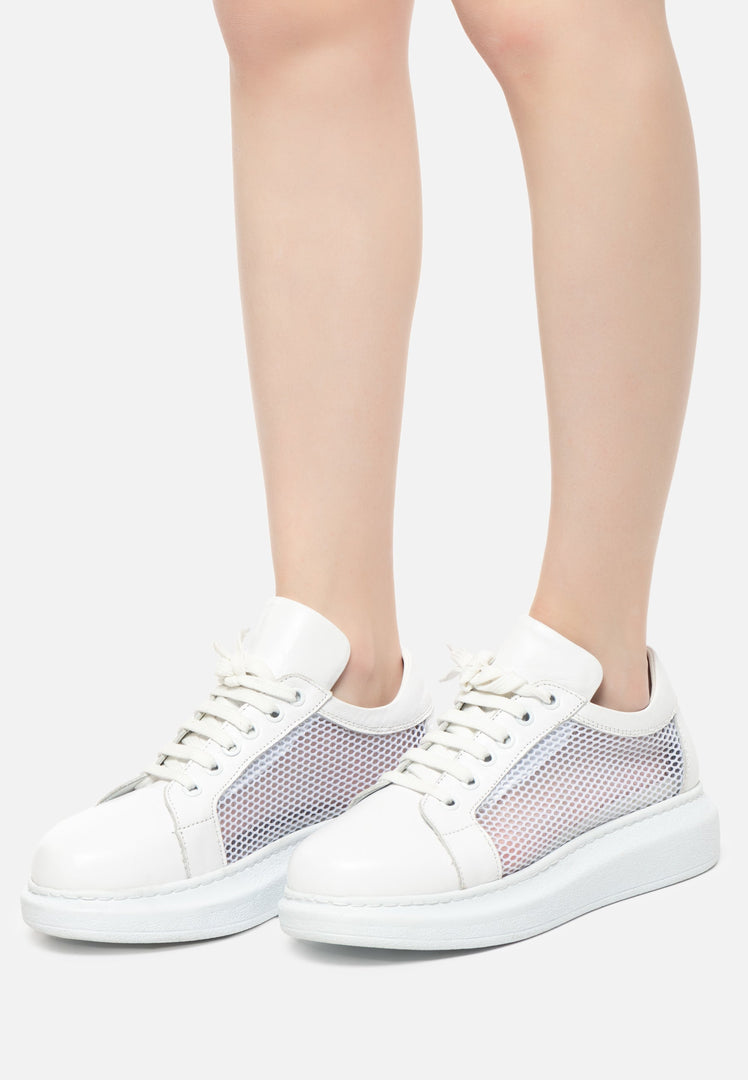 A trendy pair of white lace-up sneakers with mesh panels, perfect for athletic activities or adding a fashionable touch to any outfit.