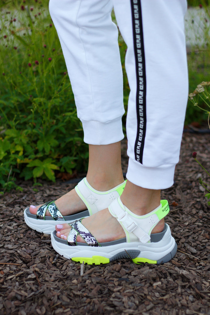 A trendy pair of white chunky strap sporty sandals, perfect for adding a sporty touch to any outfit.