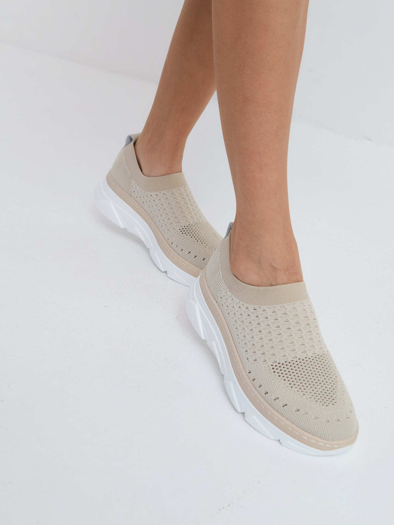 Beige slip-on sneakers in a comfortable knit material - perfect casual footwear for all-day comfort.