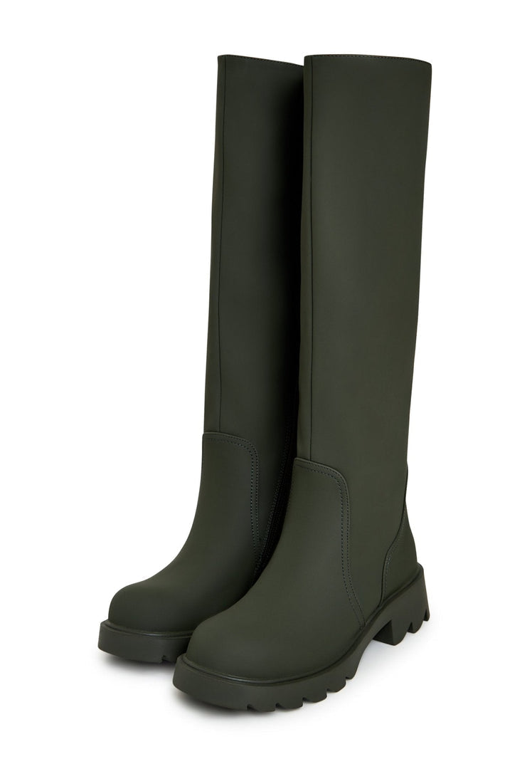 A pair of trendy green knee-high boots with chunky soles, perfect for women's fashion footwear.